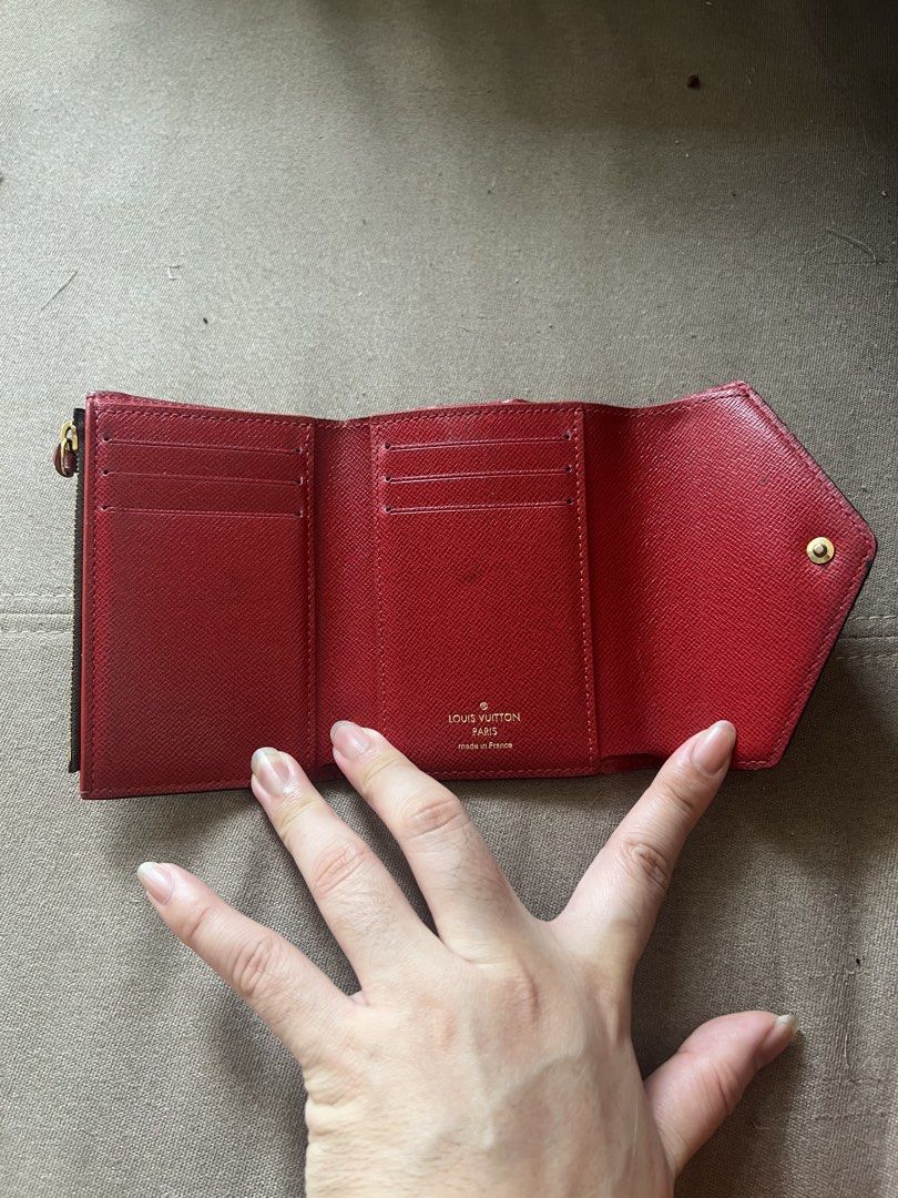 Louis Vuitton Damier Ebene Canvas Tri-fold Wallet (Category: Luxury Bags & Wallets) located in Santa Rosa. Submitted by pepperchill (Listing ID 1458708639, Image 2). Description: - Authentic Louis Vuitton Victorine wallet - Damier Ebene canvas exterior - Red interior - Multiple card slots - Zippered coin pocket - Snap button closure - Classic and essential accessory - 34,500 pa to sa LV website.