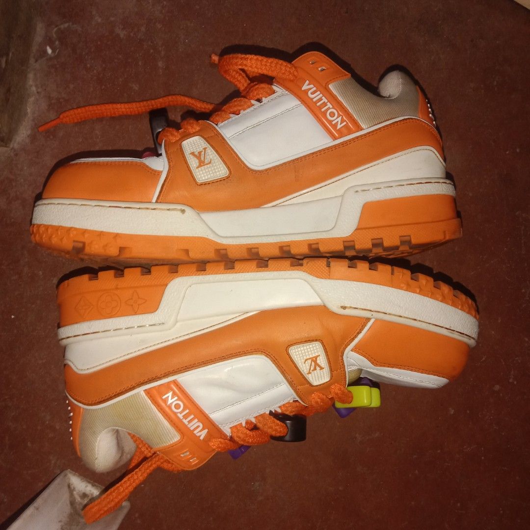 Louis Vuitton Orange White LV Trainers Sneakers (Category: Sneakers) located in Manila. Submitted by southfinds17 (Listing ID 1458737802, Image 1). Description: - Authentic Louis Vuitton trainers - Color: Orange and White - Features signature LV monogram pattern throughout - Orange soles with 'VUITTON' logo detail - Comes with original laces - Includes fun, added lace charms - Please check photos for detailed condition.