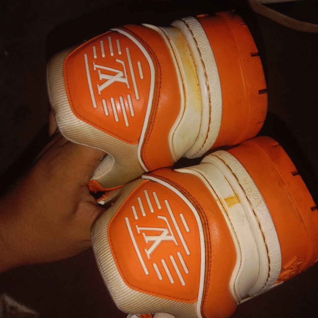 Louis Vuitton Orange White LV Trainers Sneakers (Category: Sneakers) located in Manila. Submitted by southfinds17 (Listing ID 1458737802, Image 3). Description: - Authentic Louis Vuitton trainers - Color: Orange and White - Features signature LV monogram pattern throughout - Orange soles with 'VUITTON' logo detail - Comes with original laces - Includes fun, added lace charms - Please check photos for detailed condition.