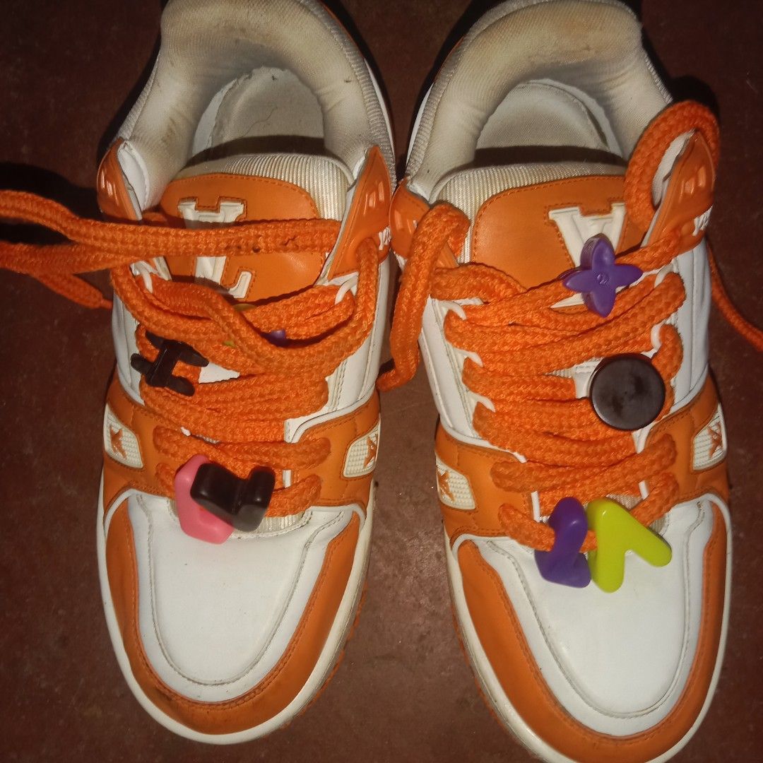Louis Vuitton Orange White LV Trainers Sneakers (Category: Sneakers) located in Manila. Submitted by southfinds17 (Listing ID 1458737802, Image 2). Description: - Authentic Louis Vuitton trainers - Color: Orange and White - Features signature LV monogram pattern throughout - Orange soles with 'VUITTON' logo detail - Comes with original laces - Includes fun, added lace charms - Please check photos for detailed condition.