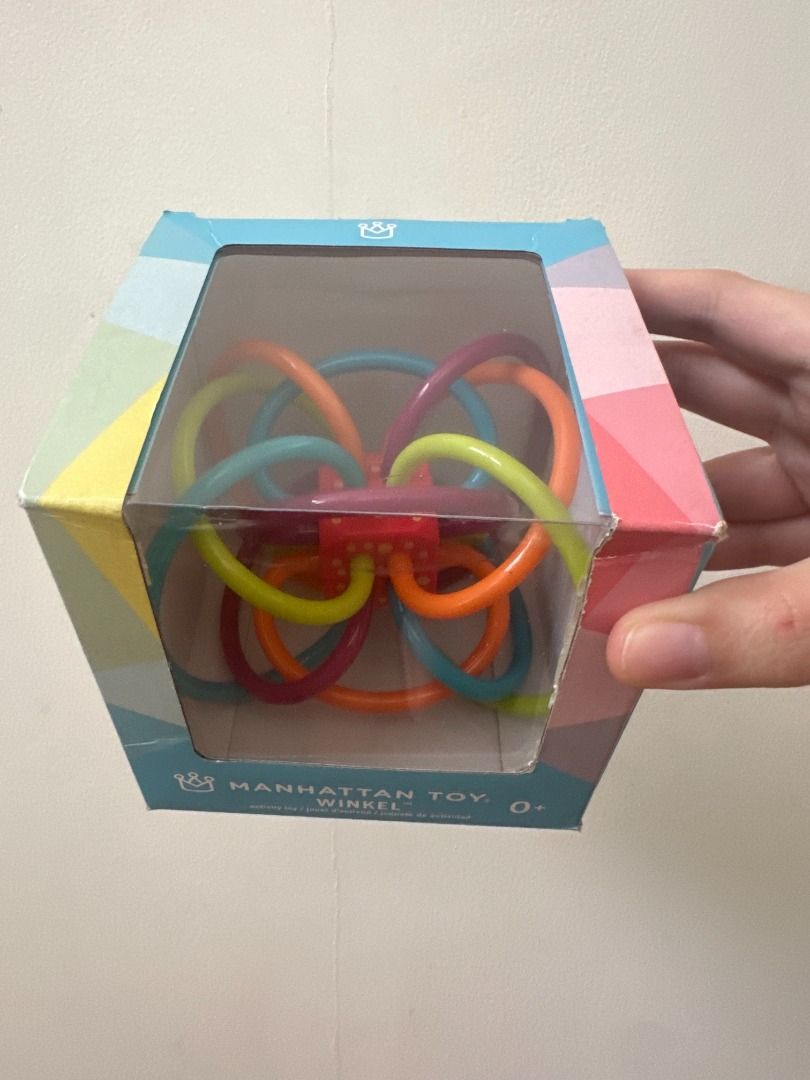 Manhattan Toy Winkel Rattle & Sensory Teether Toy (Category: Infant Playtime) located in Makati City. Submitted by travelfinds34611 (Listing ID 1458696204, Image 3). Description: Manhattan Toy Winkel Rattle & Sensory Teether Toy Color: Blue/Green/Orange - Brightly colored flexible tubes - Great for grasping and teething - Suitable for babies 0 months and up - Easy to clean: surface wash with damp cloth, rinse with baby-safe soap, air dry ORIGINAL