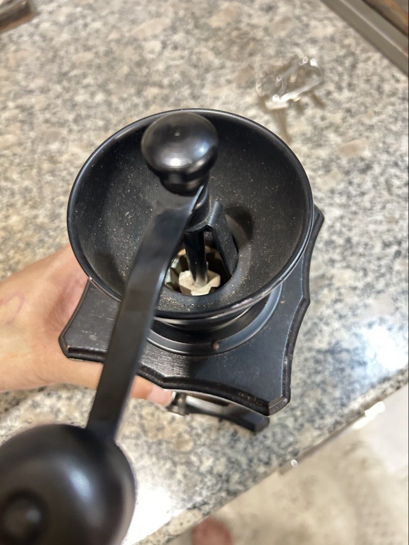 MANUAL COFFEE GRINDER (Category: Other Kitchenware & Tableware) located in Polangui. Submitted by joycehaul (Listing ID 1458785094, Image 2). Description: vintage-style manual hand-crank coffee grinder with a black wooden body, a golden crest emblem on the front, and a small pull-out drawer.