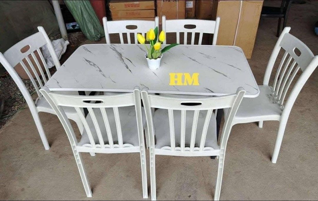 Marble Dining Table and Chairs Set (Category: Tables & Sets) located in Quezon City. Submitted by marecel146 (Listing ID 1458852279, Image 2). Description: - Elegant marble-effect dining table with a white and brown pattern. - Comes with 4 comfortable white plastic chairs. - Ideal for small dining areas or kitchens. - Easy-to-clean tabletop surface. - Sturdy legs ensure stability for the table. - Chairs are designed for comfortable everyday use..