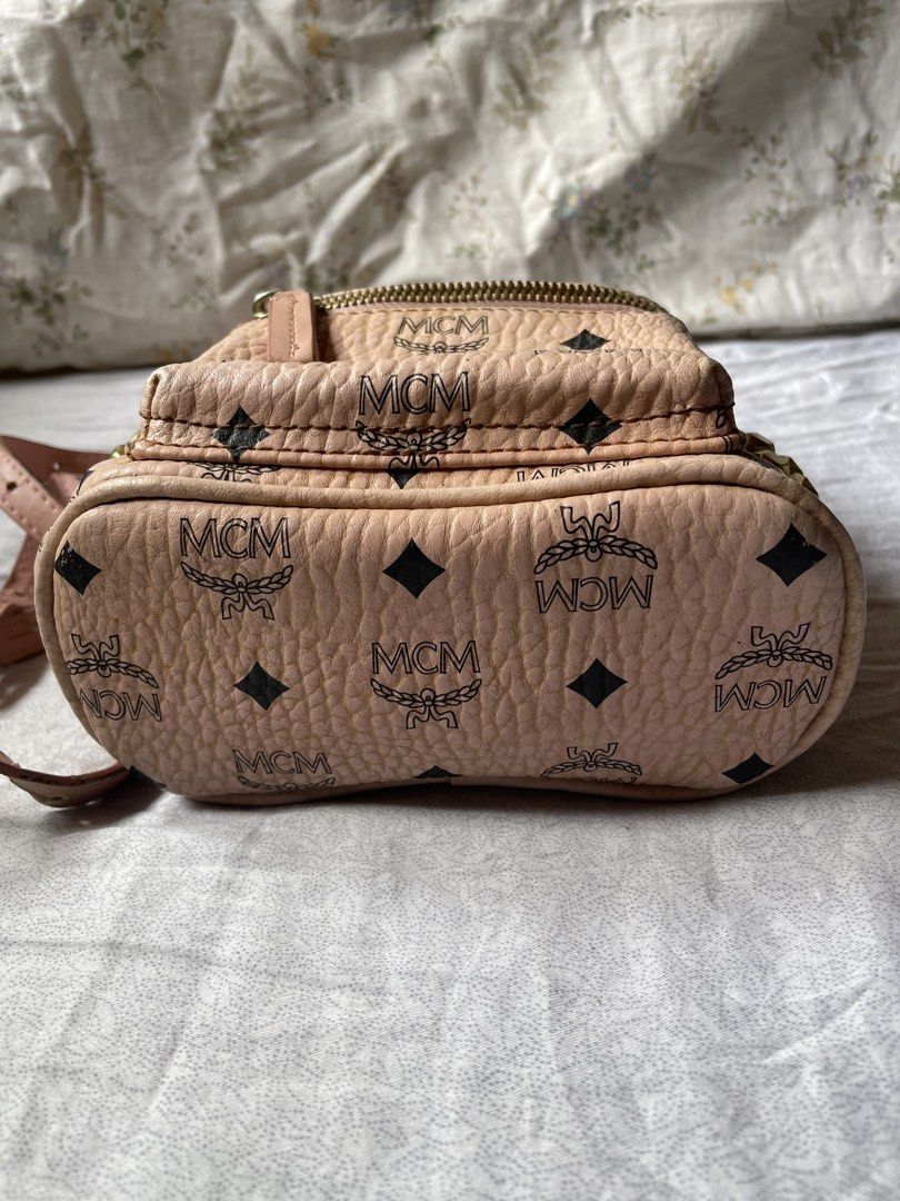 MCM Mini Backpack Pink Monogram Studded (Category: Backpacks) located in Cavite. Submitted by msandysgoodies (Listing ID 1458713829, Image 3). Description: - Authentic pink MCM mini backpack - Iconic monogram print - Gold hardware with stud details on front pocket - Adjustable straps for a comfortable fit - Compact size, ideal for carrying essentials - Shows some signs of wear on leather and hardware, adding to its character.