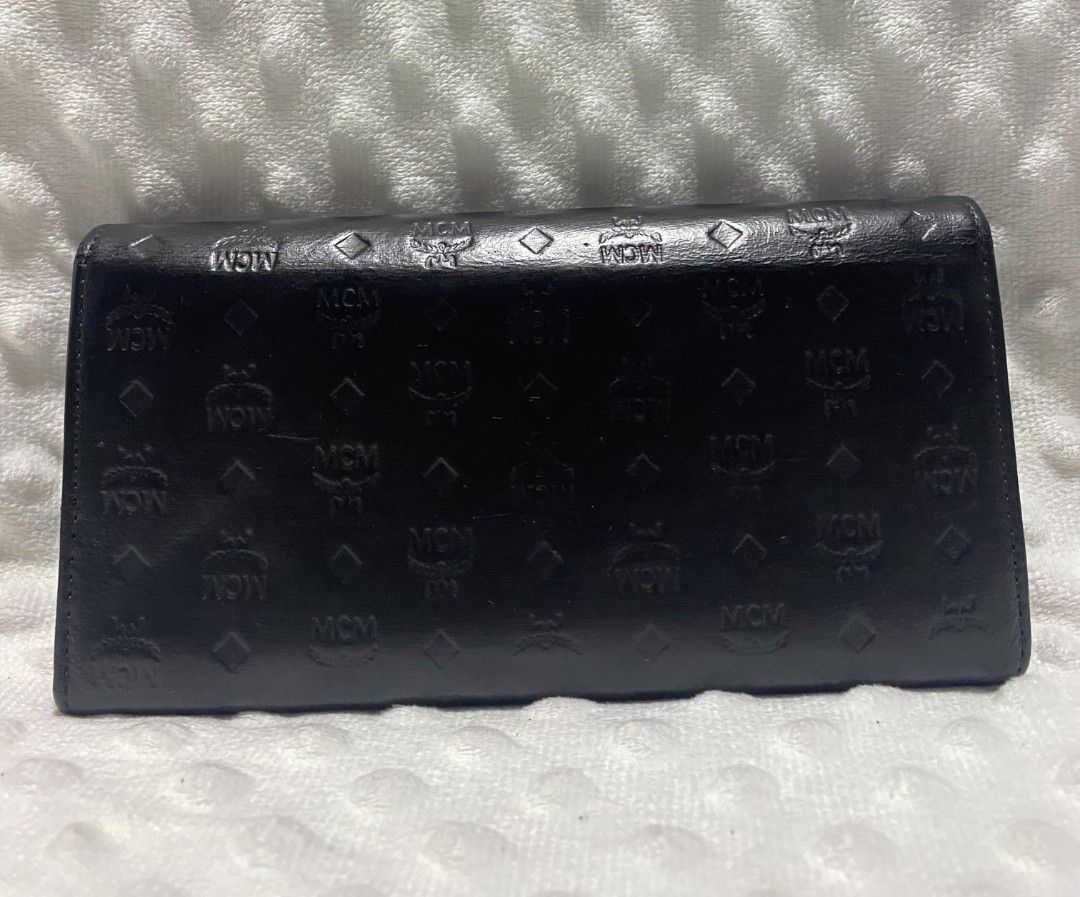 MCM Visetos Long Wallet Black (Category: Luxury Bags & Wallets) located in Tanay. Submitted by micvalcorza (Listing ID 1458822048, Image 2). Description: - Authentic MCM long wallet - Classic black Visetos monogram pattern - Vibrant purple interior - Multiple card slots and compartments for organization - Secure snap closure - Signs Of Used - 2500 PLus Ship.