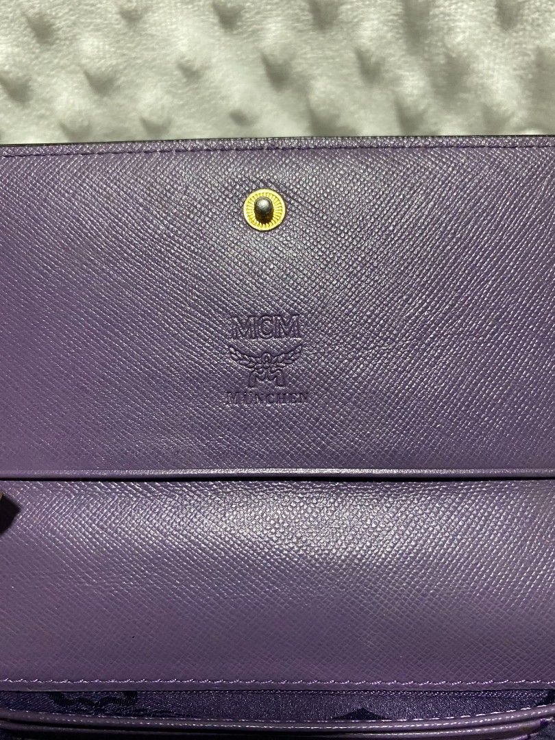 MCM Visetos Long Wallet Black (Category: Luxury Bags & Wallets) located in Tanay. Submitted by micvalcorza (Listing ID 1458822048, Image 3). Description: - Authentic MCM long wallet - Classic black Visetos monogram pattern - Vibrant purple interior - Multiple card slots and compartments for organization - Secure snap closure - Signs Of Used - 2500 PLus Ship.