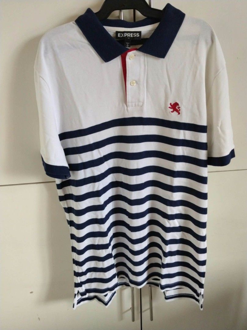 Men's Striped Polo Shirt Size M (Category: Tshirts & Polo Shirts ) located in San Juan City. Submitted by solnbart (Listing ID 1458832449, Image 1). Description: - Express Polo Shirt - Color: White with Navy Stripes - Accent: Red detail under collar - Logo: Small lion emblem on chest - Size: Medium - Ideal for: Casual wear.