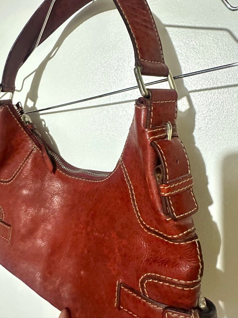 Michael Kors Red Leather Hobo Shoulder Bag (Category: Luxury Bags & Wallets) located in Manila. Submitted by classictrends_24 (Listing ID 1458735297, Image 3). Description: - Authentic Michael Kors red leather hobo bag - Classic shoulder bag style - Features stylish buckle details on the sides - Interior zippered pocket for secure storage - Made from textured leather - Ideal for everyday wear -Selling low coz color faded, zipper pull with visible