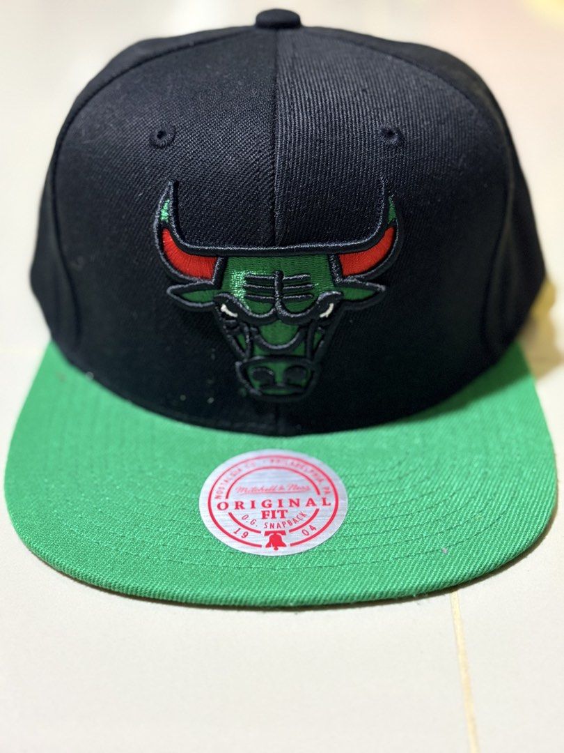 Mitchell & Ness Chicago Bulls Snapback Cap (Category: Caps & Hats) located in Subic. Submitted by aralleiah (Listing ID 1458766429, Image 1). Description: - Mitchell & Ness Chicago Bulls snapback cap - Color: Black with green brim - Features iconic red Bulls logo - Original fit - Brand new with tag still attached - A must-have for any Chicago Bulls fan!.