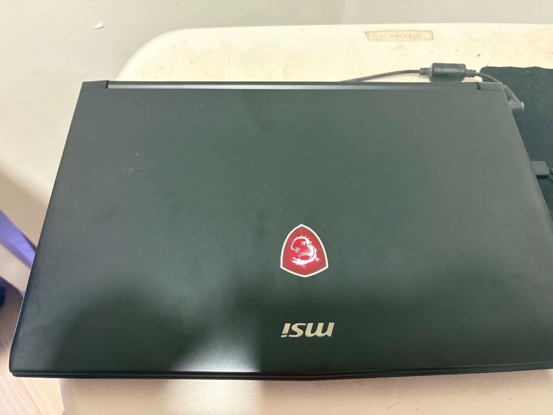 MSI GL62M 7RD (Category: Laptops & Notebooks) located in Los Banos. Submitted by emperana (Listing ID 1458805298, Image 1). Description: SEE PICS FOR SPECS. Storage is 460GB SSD. No other issues, aside from a small portion of the charger cable that was bitten by our dog. It has been secured with electrical tape. Works fine.