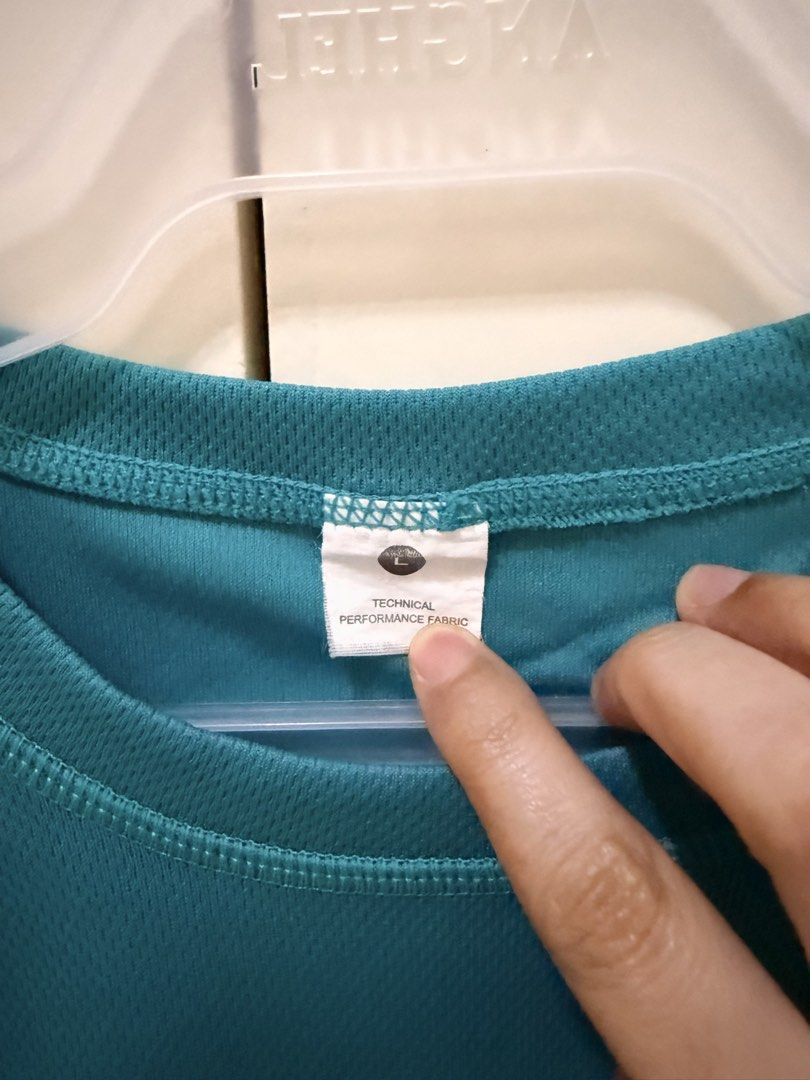 Nike Air Force 1 Teal Technical Performance Fabric T-Shirt (Category: Shirts) located in Los Banos. Submitted by ramrammms (Listing ID 1458772064, Image 2). Description: - Teal Nike Air Force 1 T-shirt - Made with technical performance fabric - Ideal for workouts or casual wear - Size: Large - Comfortable and stylish.