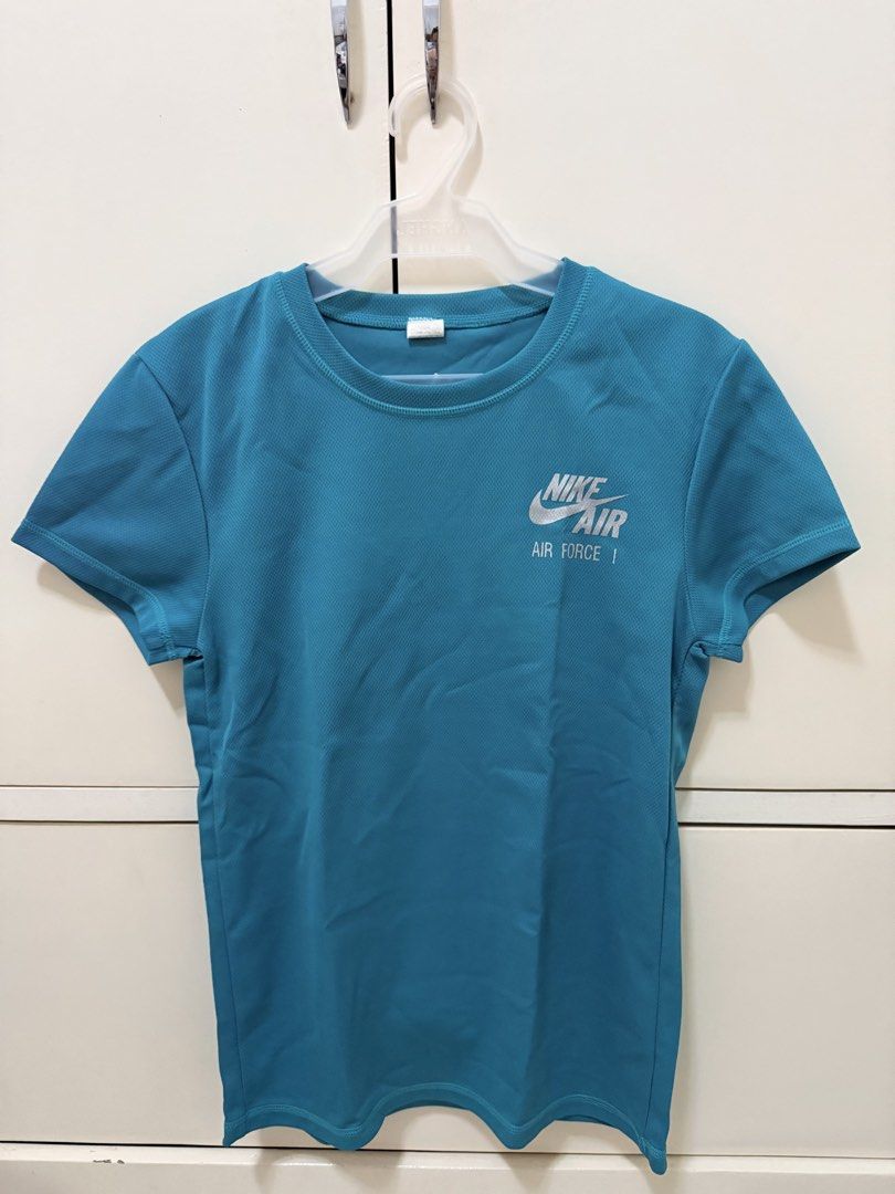 Nike Air Force 1 Teal Technical Performance Fabric T-Shirt (Category: Shirts) located in Los Banos. Submitted by ramrammms (Listing ID 1458772064, Image 1). Description: - Teal Nike Air Force 1 T-shirt - Made with technical performance fabric - Ideal for workouts or casual wear - Size: Large - Comfortable and stylish.