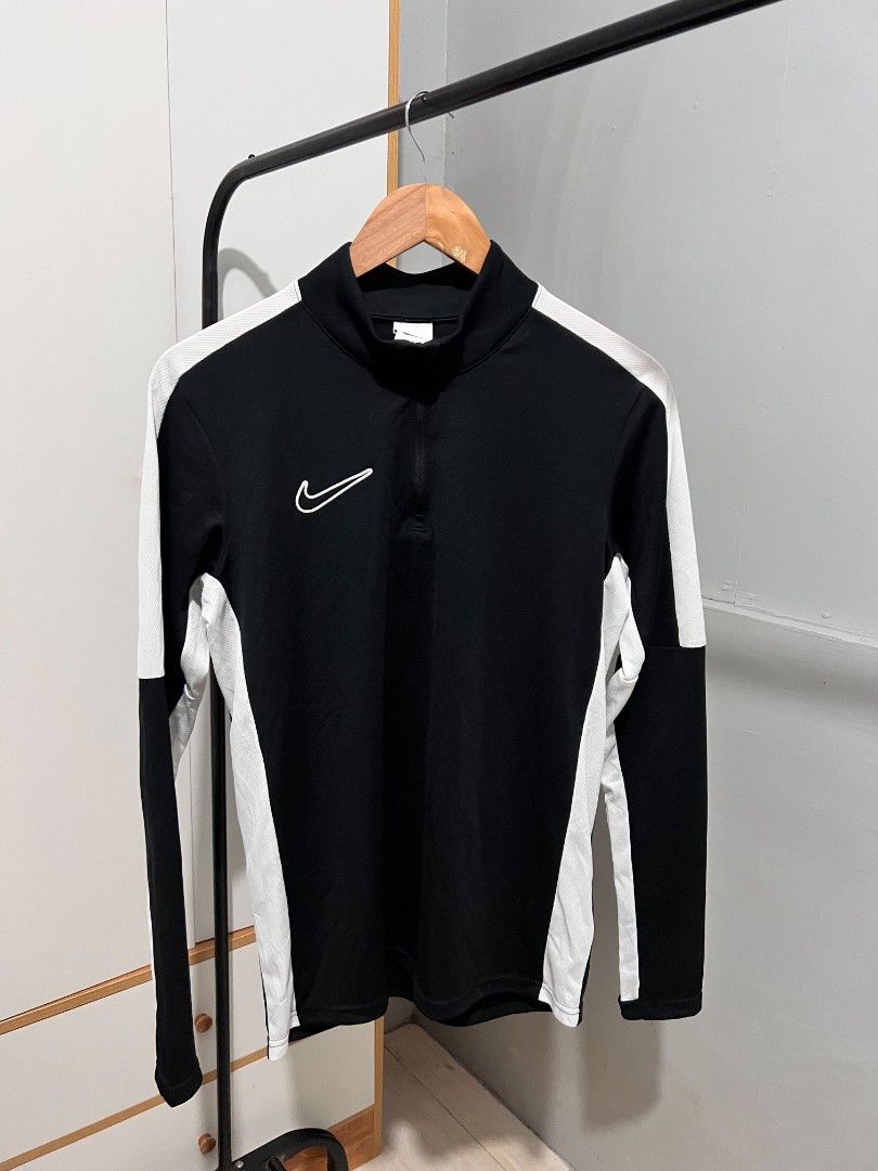 Nike Dri-FIT Black White Track Jacket (Category: Coats, Jackets and Outerwear) located in Manila. Submitted by swifttree-5145 (Listing ID 1458725033, Image 1). Description: - Black and white Nike track jacket - Features a quarter zip closure - Made with Dri-FIT material for sweat-wicking - Comfortable and breathable fabric - Ideal for sports activities or casual everyday wear - Nike logo prominently displayed on the chest.