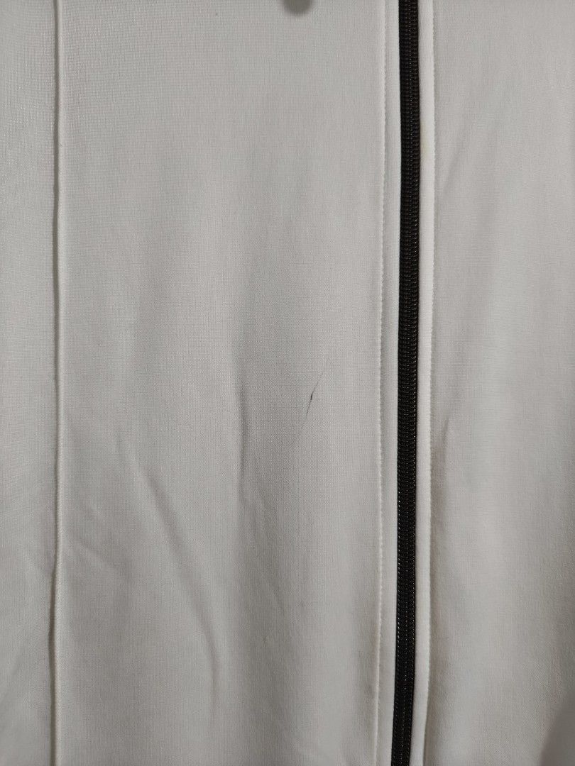 Nike Track Jacket White Brown Zip Up (Category: Coats, Jackets and Outerwear) located in Manila. Submitted by bmsthrift (Listing ID 1458762480, Image 2). Description: - White Nike track jacket - Brown accents on sleeves and hem - Full zip closure with YKK zipper - Small red Nike logo on chest - Minor marks on fabric (see close-up photos) - Perfect for casual wear or sports.