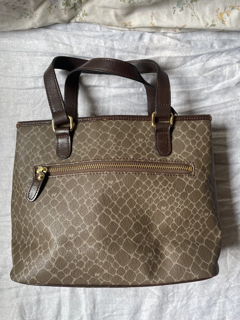 Nina Ricci NR Monogram Tote Bag (Category: Luxury Bags & Wallets) located in Cavite. Submitted by msandysgoodies (Listing ID 1458714632, Image 3). Description: - Classic Nina Ricci tote bag - Signature NR monogram pattern all over - Dark brown leather trim and handles - Gold hardware details - Zipper closure on back pocket - Four metal studs on the bottom for protection - Stylish and practical for everyday use.