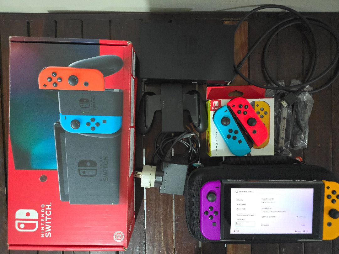 Nintendo Switch (V2) Console with Joy-Cons and Accessories (Category: Nintendo) located in Calamba. Submitted by basicallyodd23 (Listing ID 1458811035, Image 2). Description: FS: Nintendo Switch V2 (Hong Kong) With: - carrying case - SD card (128 GB) - extra Joycons (stick drift on left blue Joycon) - Joycon holder - charger w/ adapter - original HDMI cable - original box Meet-ups w/in Calamba City, Laguna only..