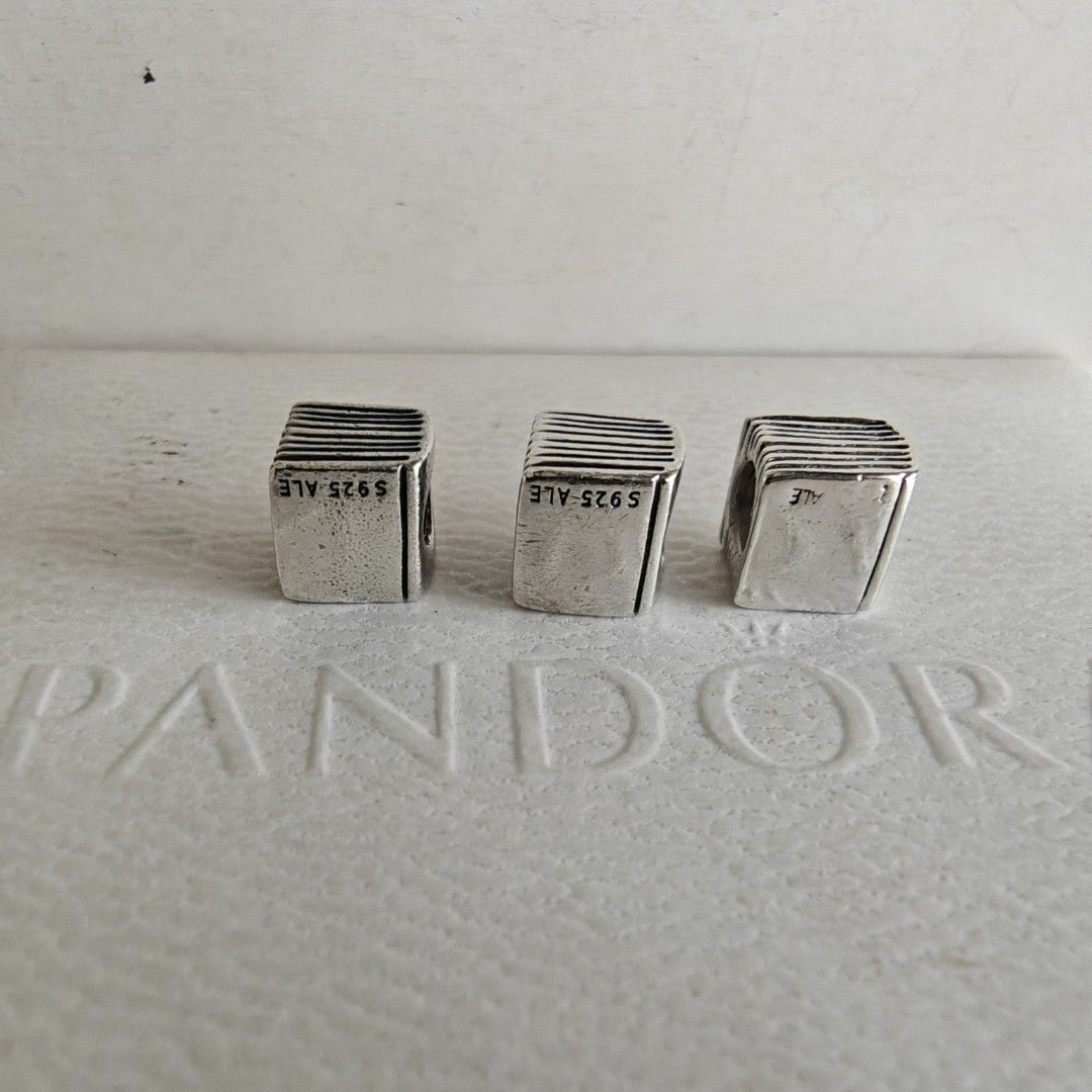 Pandora bible charm (Category: Charms) located in Makati City. Submitted by ly12eb (Listing ID 1458699560, Image 2). Description: Authentic Excellent condition Right - worn out marks, 1.2k Left and middle - 1.4k each.