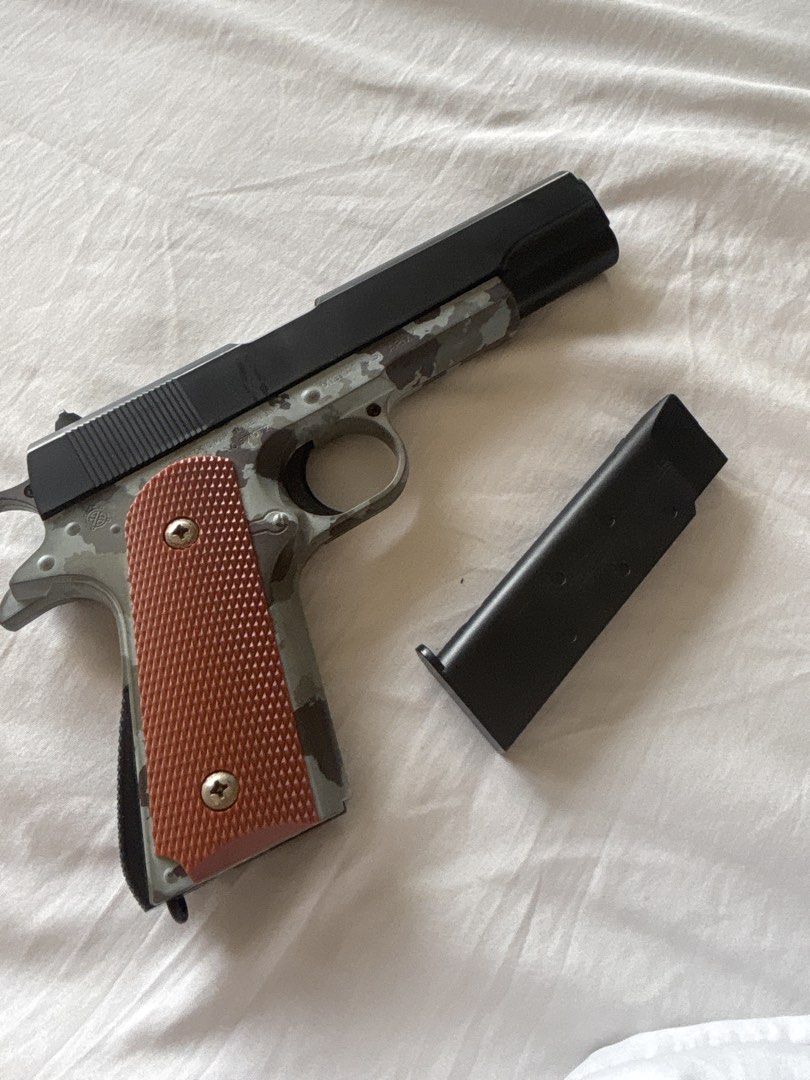 Pellet Toy Gun (Colt M1911 Model) (Category: Action & Battle Toys) located in Makati City. Submitted by beammf (Listing ID 1458738828, Image 3). Description: Mint Camo Brown handle and Black Skin. Reloadable and can support Ball pellets.