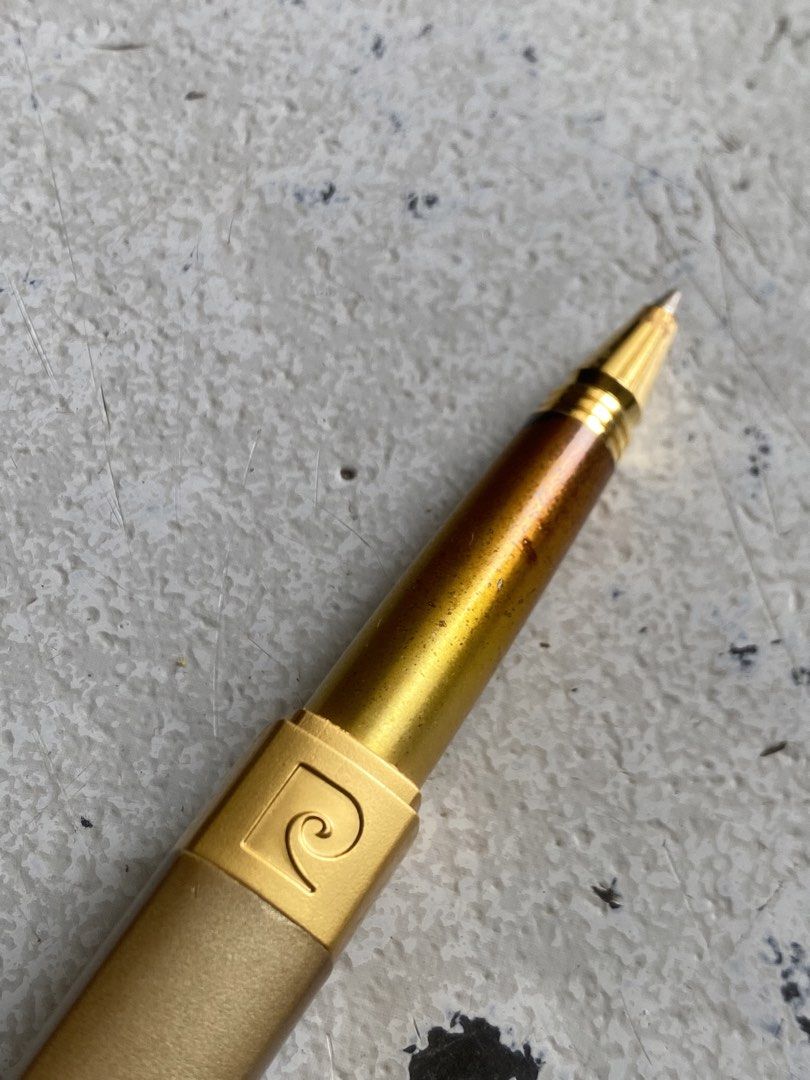 Pierre Cardin Gold Ballpoint Pen (Category: Stationery & School Supplies) located in General Trias. Submitted by mangu_ukay (Listing ID 1458786480, Image 3). Description: - Genuine Pierre Cardin gold ballpoint pen - Features signature logo on the clip - Shows minor scuffs and discoloration on barrel (normal wear) - Writes smoothly and reliably - A timeless writing accessory.