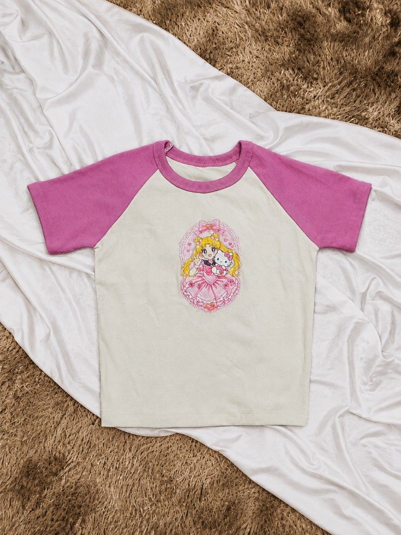 Pink & Cream Kawaii Graphic Raglan Tee (Category: Blouses) located in Manila. Submitted by dear.naiah (Listing ID 1458754513, Image 1). Description: •Cream body with pink raglan sleeves •Cute anime-inspired graphic print •Soft, feminine color combination •Classic crew neckline •Casual & playful Y2K-inspired style.
