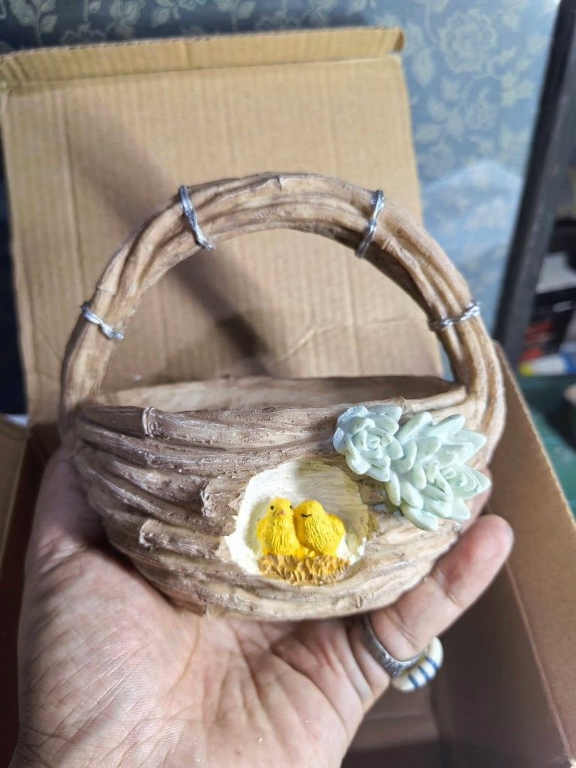 Polyresin Wicker Basket Planter (Category: Pots & Planters) located in Cebu City. Submitted by dudes_villanueva (Listing ID 1458696089, Image 1). Description: Polyresin Wicker Basket Planter Brand New with Box 📌 Featuring a cute little bird's nest with two yellow chicks and an attached succulent detail. L5.25xW3.75xH4.75 (Handle included).