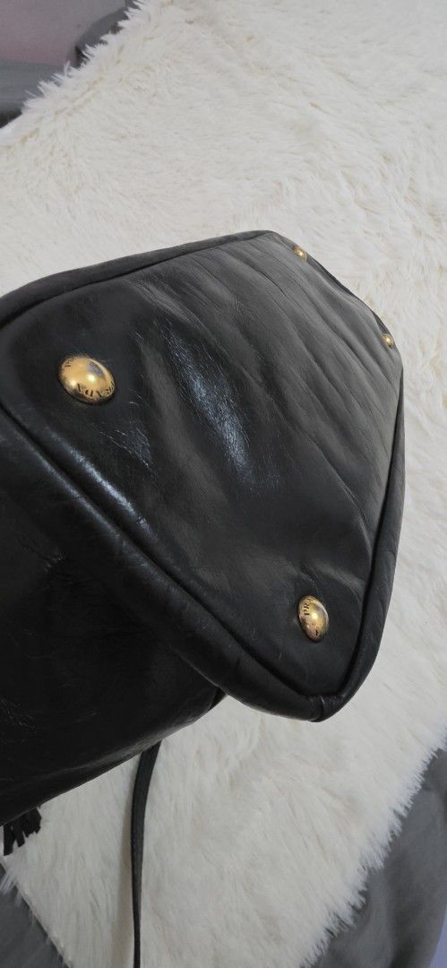 Prada Black Leather Top Handle Bag (Category: Luxury Bags & Wallets) located in Pasig City. Submitted by lfboutique (Listing ID 1458779983, Image 3). Description: pasig loc no cod no damage, professionally recolored minor fade on hardware pls see photos for reference - Authentic black leather Prada handbag - Elegant gold hardware details - Versatile top handle and detachable shoulder strap - Protective studs on the bottom - Shows some signs of we