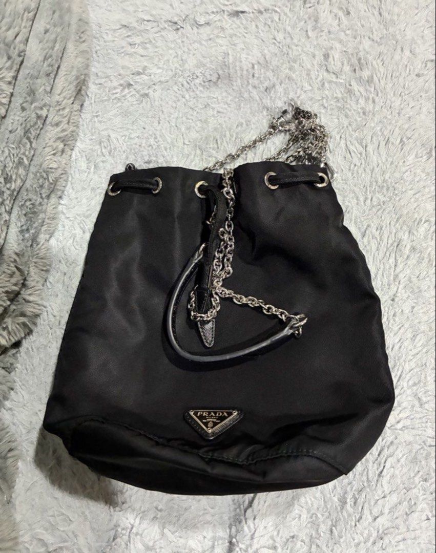 Prada Nylon Drawstring pouch with Sling (Category: Cross-body Bags) located in Cebu City. Submitted by hannahkimberlychica (Listing ID 1458733442, Image 1). Description: Prada Nylon Drawstring pouch with Sling - Pre-loved / good condition - Japan surplus - With chain strap - Silver- tone chain detailing with the Prada signature triangular logo RFS: Wasn’t able to use it that much, so letting it go. 📍 Cebu Shipping fee c/o buyer PM for more photo