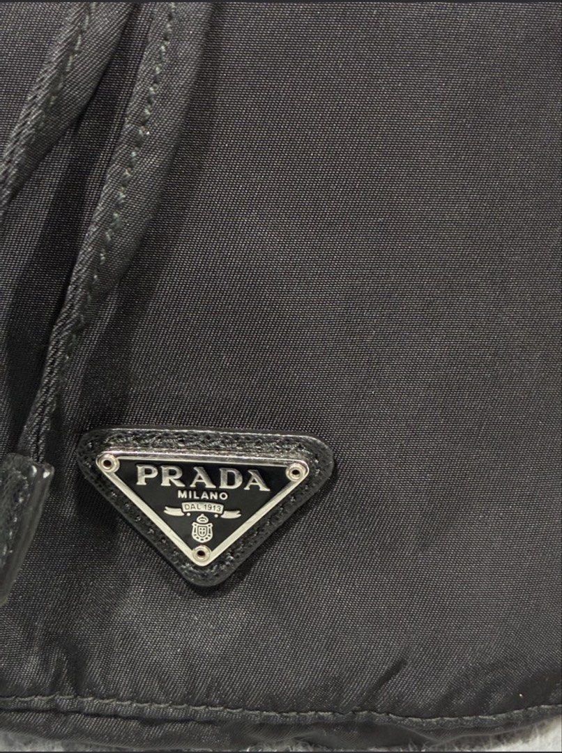 Prada Nylon Drawstring pouch with Sling (Category: Cross-body Bags) located in Cebu City. Submitted by hannahkimberlychica (Listing ID 1458733442, Image 2). Description: Prada Nylon Drawstring pouch with Sling - Pre-loved / good condition - Japan surplus - With chain strap - Silver- tone chain detailing with the Prada signature triangular logo RFS: Wasn’t able to use it that much, so letting it go. 📍 Cebu Shipping fee c/o buyer PM for more photo