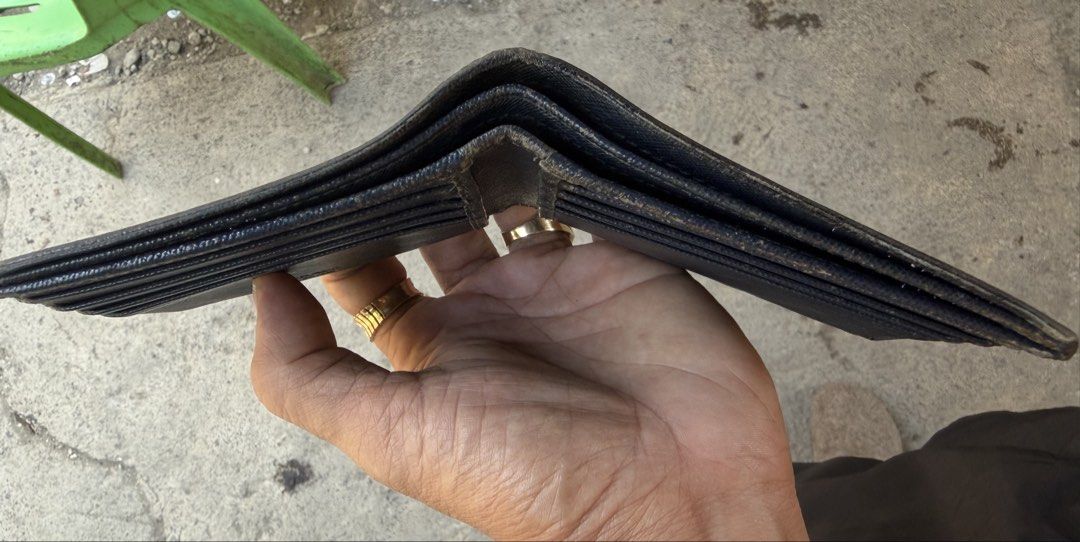 Prada Saffiano Leather Bi-fold Wallet (Category: Luxury Bags & Wallets) located in Manila. Submitted by raven236 (Listing ID 1458749963, Image 3). Description: - Prada bi-fold wallet - Black Saffiano leather - Functional interior with multiple card slots and bill compartments - Classic piece, still has plenty of life left for everyday use.