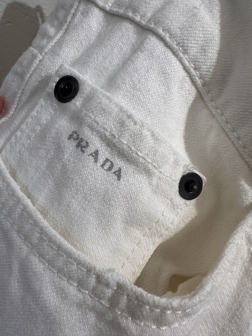 Prada White Denim Jeans (Category: Jeans) located in Pasay City. Submitted by adoseofluxxee (Listing ID 1458779479, Image 3). Description: - Authentic Prada Jeans - Classic Five-Pocket Style - Button and Zip Closure - Subtle Prada Branding on Back Pocket & Button - Straight Leg Fit.