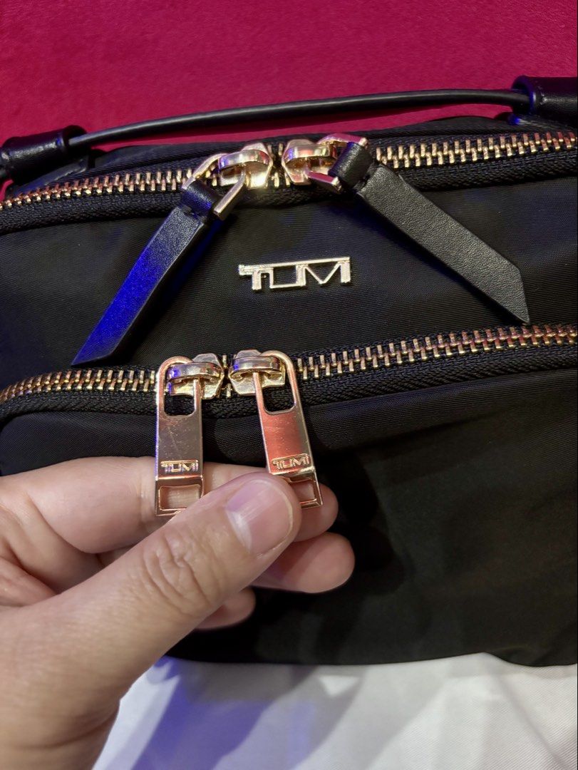 Preloved Teghan Crossbody Bag (Category: Cross-body Bags) located in Malolos. Submitted by cheerz21 (Listing ID 1458779406, Image 3). Description: Preloved Tumi Teghan Crossbody Bag •Nylon, water-proof bag •With dust bag; Top Notch/ OG quality •Double-zip entry to main compartment •Back open pocket with hidden magnetic snap closure • Collapsible leather top handle •Removable and adjustable strap • Monogrammable detachable leather charm • 4 metal 