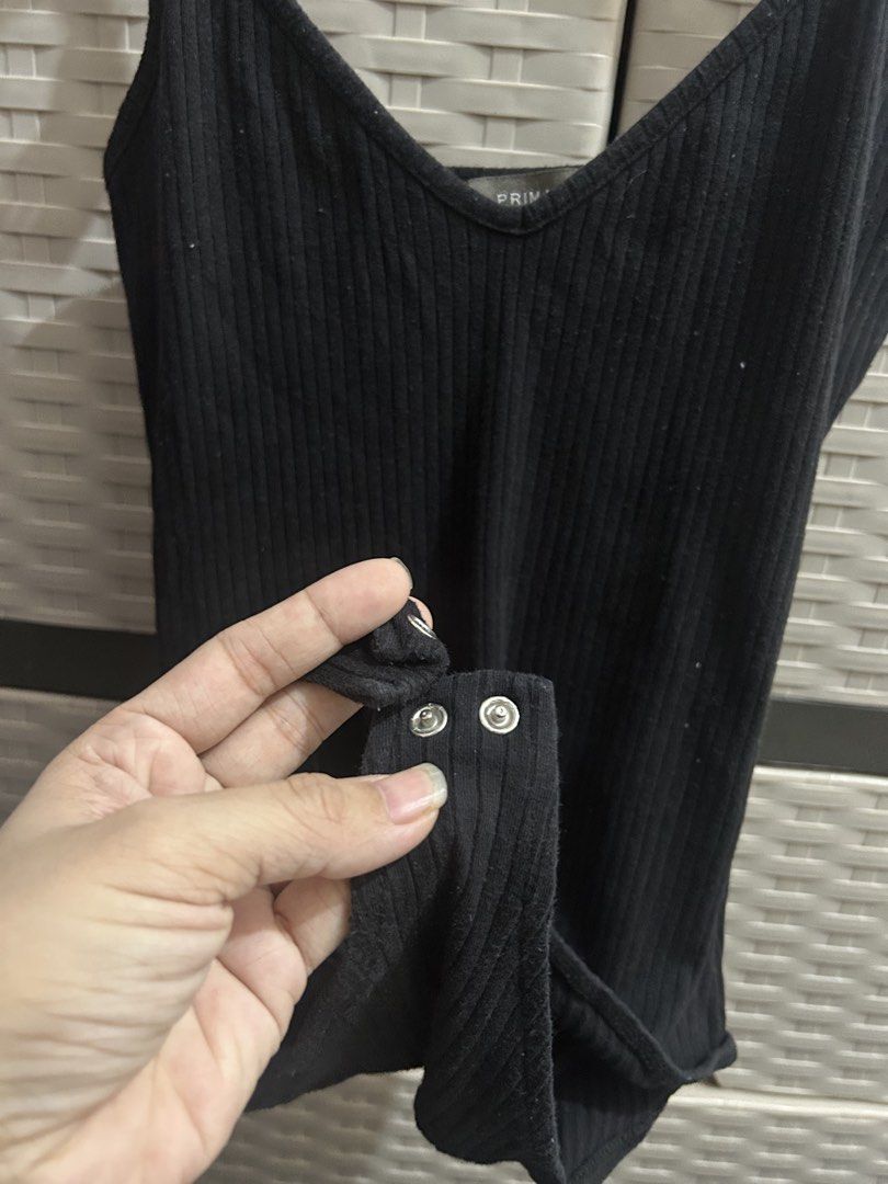 Primark Black Ribbed Spaghetti Strap Bodysuit (Category: Sleeveless) located in San Jose. Submitted by abbsc. (Listing ID 1458718178, Image 2). Description: - Brand: Primark - Small-med in siz - Color: Black - Style: Ribbed bodysuit - Features: Spaghetti straps, V-neckline - Closure: Snap button at crotch - Material: Stretchy for comfort - Versatile basic piece.