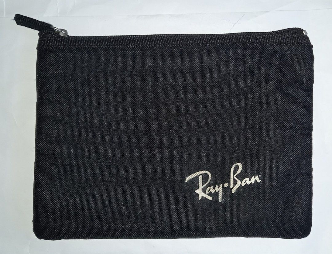 Ray-Ban Black Zipper Pouch (Category: Purses & Pouches) located in Cagayan de Oro. Submitted by edwardryan01984 (Listing ID 1458710840, Image 1). Description: - Black pouch with iconic Ray-Ban logo - Secure zipper closure - Ideal for storing sunglasses, makeup, stationery, and other small essentials - Made from durable material for long-lasting use - Simple, functional design suitable for everyday carry or travel.