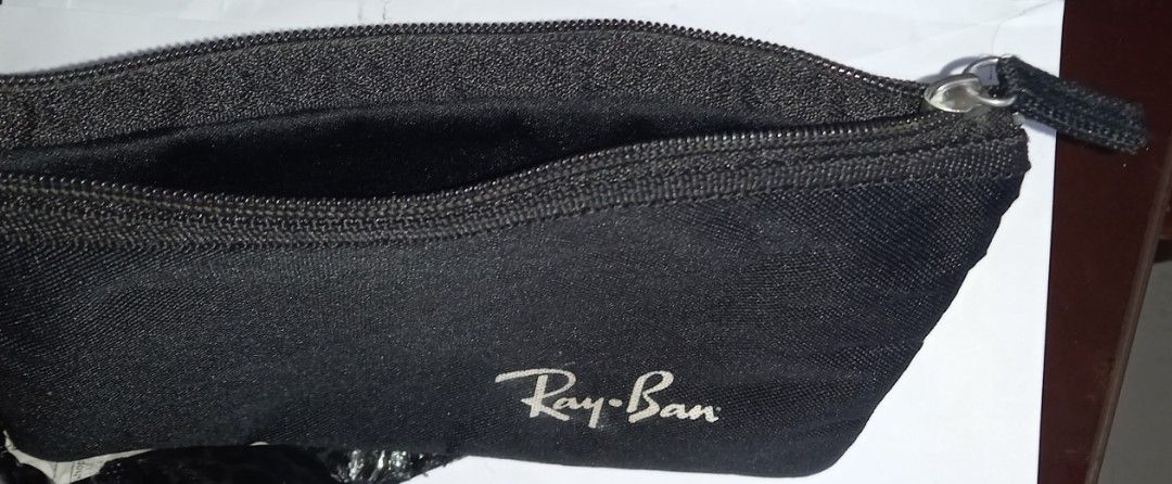 Ray-Ban Black Zipper Pouch (Category: Purses & Pouches) located in Cagayan de Oro. Submitted by edwardryan01984 (Listing ID 1458710840, Image 3). Description: - Black pouch with iconic Ray-Ban logo - Secure zipper closure - Ideal for storing sunglasses, makeup, stationery, and other small essentials - Made from durable material for long-lasting use - Simple, functional design suitable for everyday carry or travel.