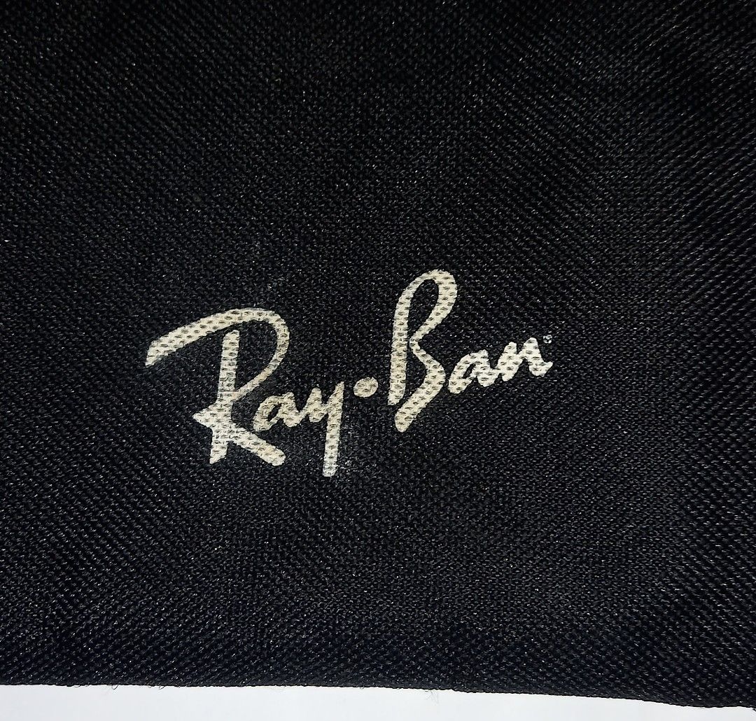 Ray-Ban Black Zipper Pouch (Category: Purses & Pouches) located in Cagayan de Oro. Submitted by edwardryan01984 (Listing ID 1458710840, Image 2). Description: - Black pouch with iconic Ray-Ban logo - Secure zipper closure - Ideal for storing sunglasses, makeup, stationery, and other small essentials - Made from durable material for long-lasting use - Simple, functional design suitable for everyday carry or travel.