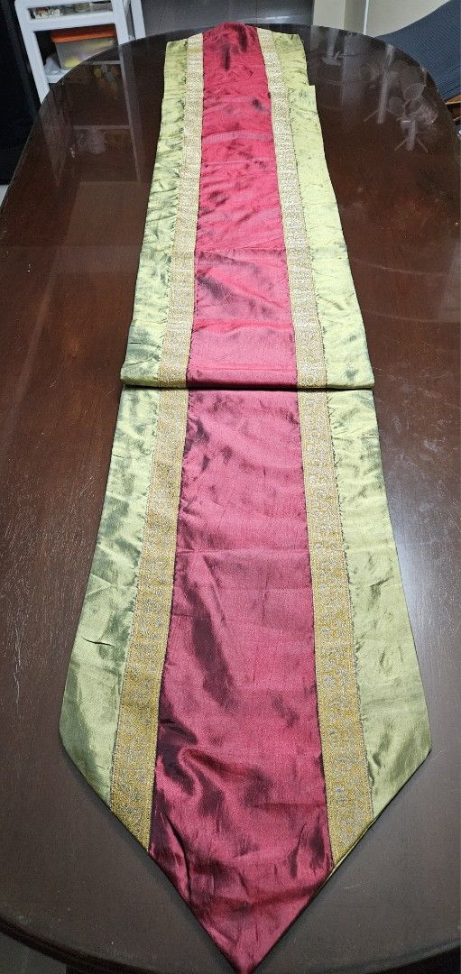 Red and Green Silk Table Runner with Gold Trim (Category: Table Linen & Textiles) located in Caloocan City. Submitted by rm.diaz (Listing ID 1458781886, Image 1). Description: - Rich red center with contrasting light green sides table runner - Elegant gold trim along the edges. - Adds a festive and special touch to your dining table. - Versatile for special occasions or everyday elegance. - Measures 97 x 13 inches - ideal for a long table- 10 to 