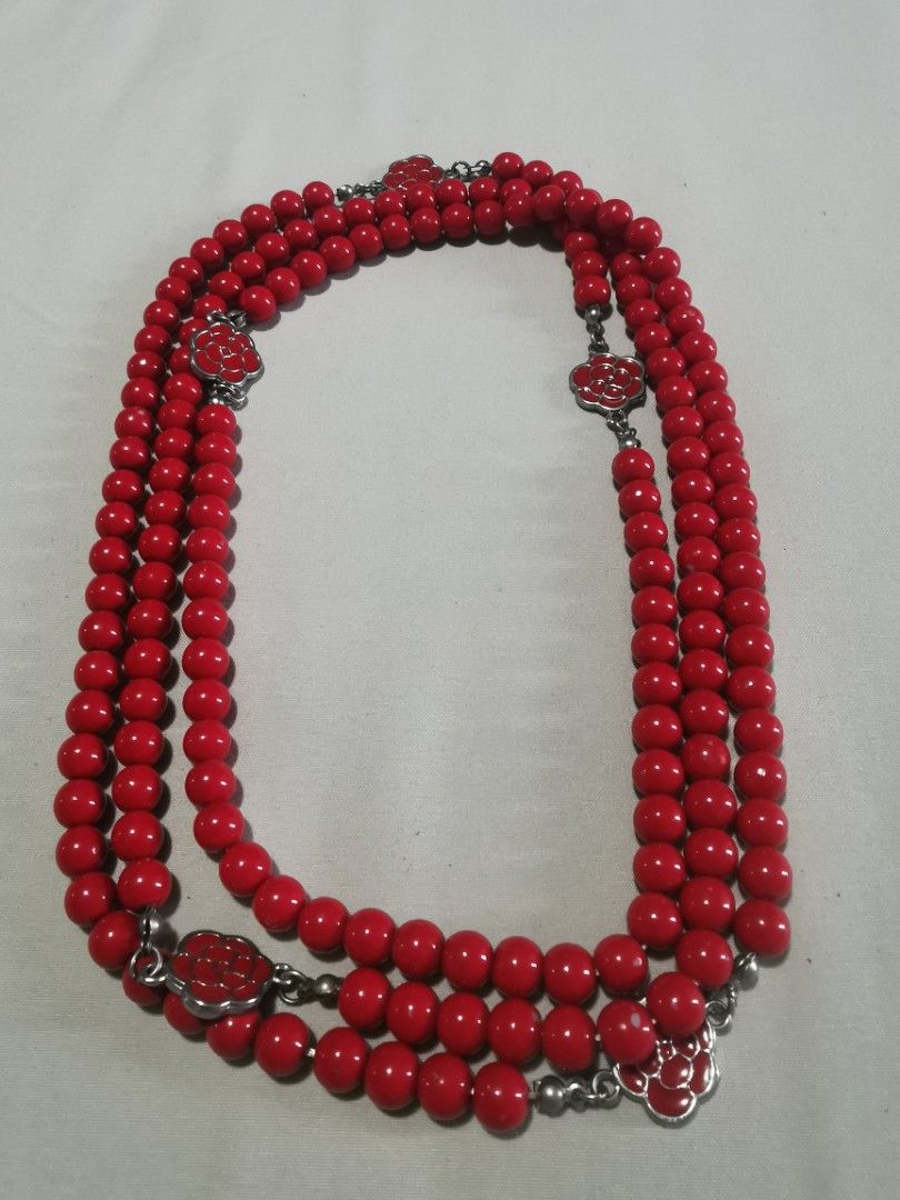 Red Beaded Necklace with Flower Charms (Category: Necklaces) located in Makati City. Submitted by denvergirl1119 (Listing ID 1458752120, Image 1). Description: - vintage Japan accessories long necklace Three strands of bright red beads - Silver-tone chains with red flower charms - Charms feature a floral design - Long necklace length - Adds a pop of color to any outfit - Perfect statement piece.