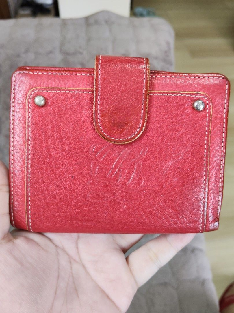 Red Leather Wallet with Embossed Logo (Category: Wallets & Card holders) located in Navotas City. Submitted by pereznahnah (Listing ID 1458758999, Image 1). Description: - Red leather bifold wallet - Embossed logo on the front - Interior card slots and clear ID window - Secure snap closure - Shows some signs of wear on leather, particularly edges and closure - Fully functional and retains its stylish appeal.