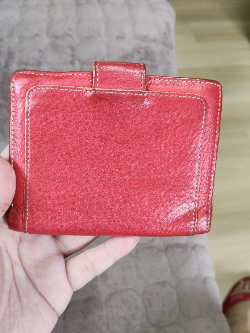 Red Leather Wallet with Embossed Logo (Category: Wallets & Card holders) located in Navotas City. Submitted by pereznahnah (Listing ID 1458758999, Image 2). Description: - Red leather bifold wallet - Embossed logo on the front - Interior card slots and clear ID window - Secure snap closure - Shows some signs of wear on leather, particularly edges and closure - Fully functional and retains its stylish appeal.