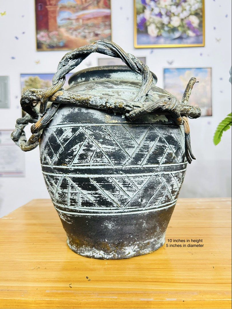 Rustic Clay Jar (Category: Vases & Decorative Bowls) located in Bustos. Submitted by gthings.collectibles (Listing ID 1458785861, Image 1). Description: ✨ Vintage Vibes para sa Inyong Tahanan! Yours at ₱450 only !! ✨Looking for that perfect statement piece? Check out this unique, rustic earthenware jar with intricate tribal-style carvings and a beautifully distressed finish. Ito ay may taas na 10 inches at diameter na 5 inches—sakto lang ipatong 