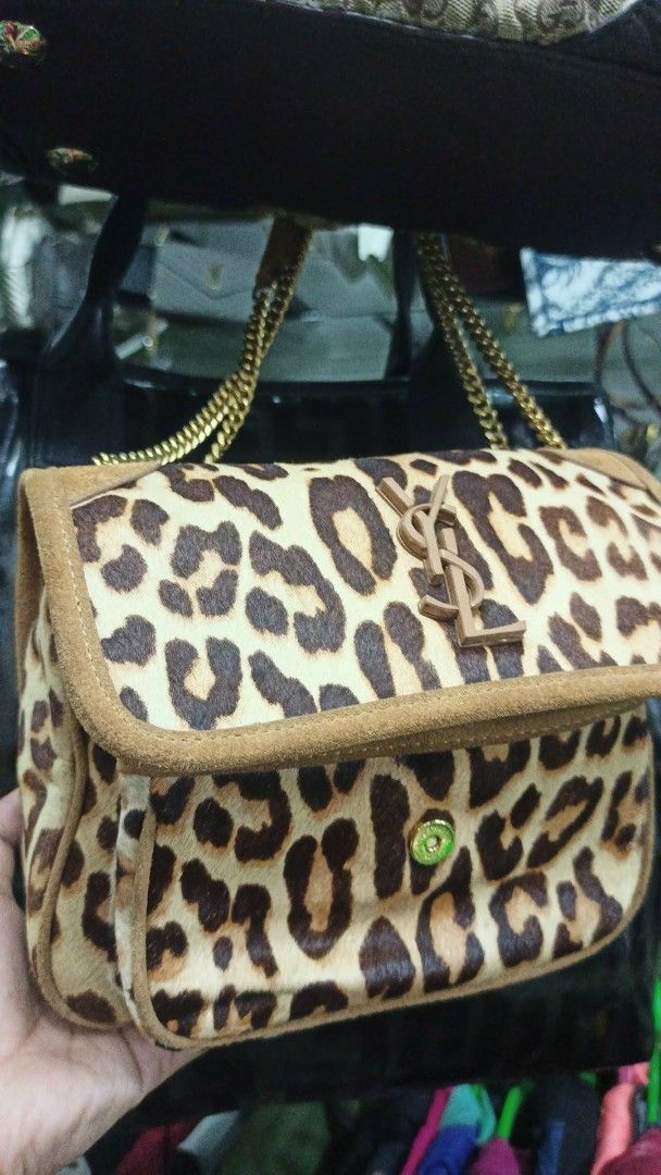 Saint Laurent Leopard Print Suede Chain Shoulder Bag (Category: Luxury Bags & Wallets) located in Baguio. Submitted by XycerlynCLXN (Listing ID 1458801779, Image 1). Description: - Eye-catching leopard print shoulder bag - Luxurious suede trim - Elegant gold chain strap - Iconic YSL logo on the front flap - Interior: Main compartment + smaller pocket - Versatile: Perfect for statement outfits, nights out, or everyday chic.