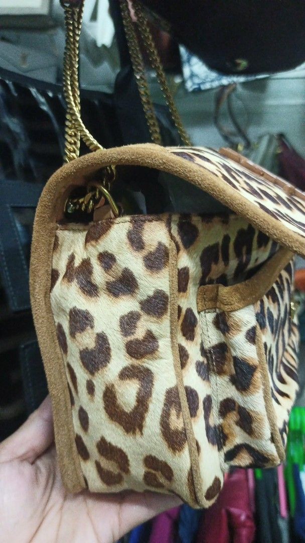 Saint Laurent Leopard Print Suede Chain Shoulder Bag (Category: Luxury Bags & Wallets) located in Baguio. Submitted by XycerlynCLXN (Listing ID 1458801779, Image 3). Description: - Eye-catching leopard print shoulder bag - Luxurious suede trim - Elegant gold chain strap - Iconic YSL logo on the front flap - Interior: Main compartment + smaller pocket - Versatile: Perfect for statement outfits, nights out, or everyday chic.