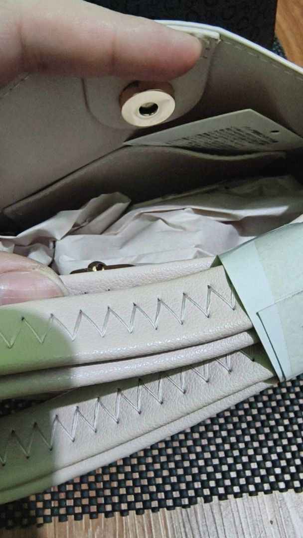 SILFIEL Beige Leather Bucket Bag (Category: Luxury Bags & Wallets) located in Manila. Submitted by akosijapok (Listing ID 1458731447, Image 3). Description: - Brand: SILFIEL - Color: Beige - Material: Genuine Leather - Features: Top handle, detachable strap, magnetic snap closure - Design: Clean and simple bucket bag style - Condition: Excellent, still contains original paper stuffing Design Features: Silhouette: It has a structured, rectangular 