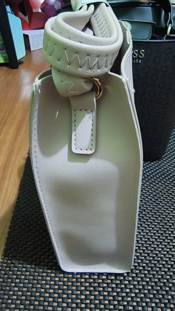 SILFIEL Beige Leather Bucket Bag (Category: Luxury Bags & Wallets) located in Manila. Submitted by akosijapok (Listing ID 1458731447, Image 2). Description: - Brand: SILFIEL - Color: Beige - Material: Genuine Leather - Features: Top handle, detachable strap, magnetic snap closure - Design: Clean and simple bucket bag style - Condition: Excellent, still contains original paper stuffing Design Features: Silhouette: It has a structured, rectangular 