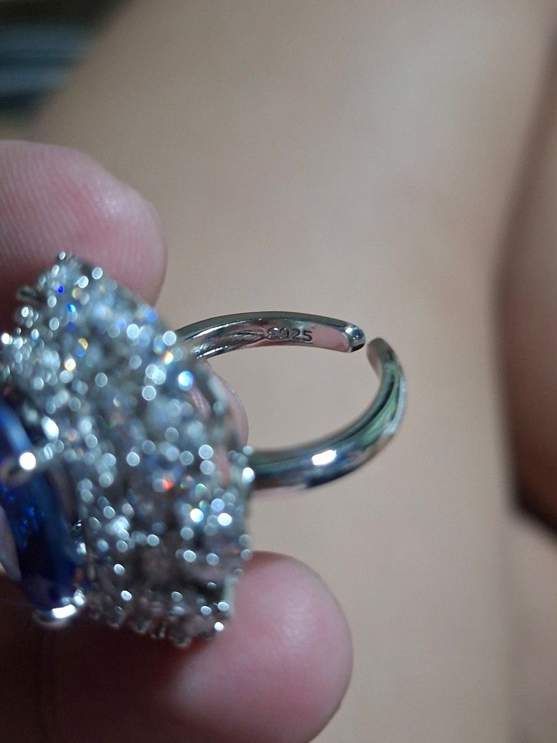 Silver Ring with Blue Stone and Crystals (Category: Rings) located in Muntinlupa City. Submitted by jsassorteditems (Listing ID 1458718297, Image 2). Description: - Adjustable silver ring - Features a large teardrop blue stone - Surrounded by small clear crystals - Adds sparkle and a unique touch to any outfit.