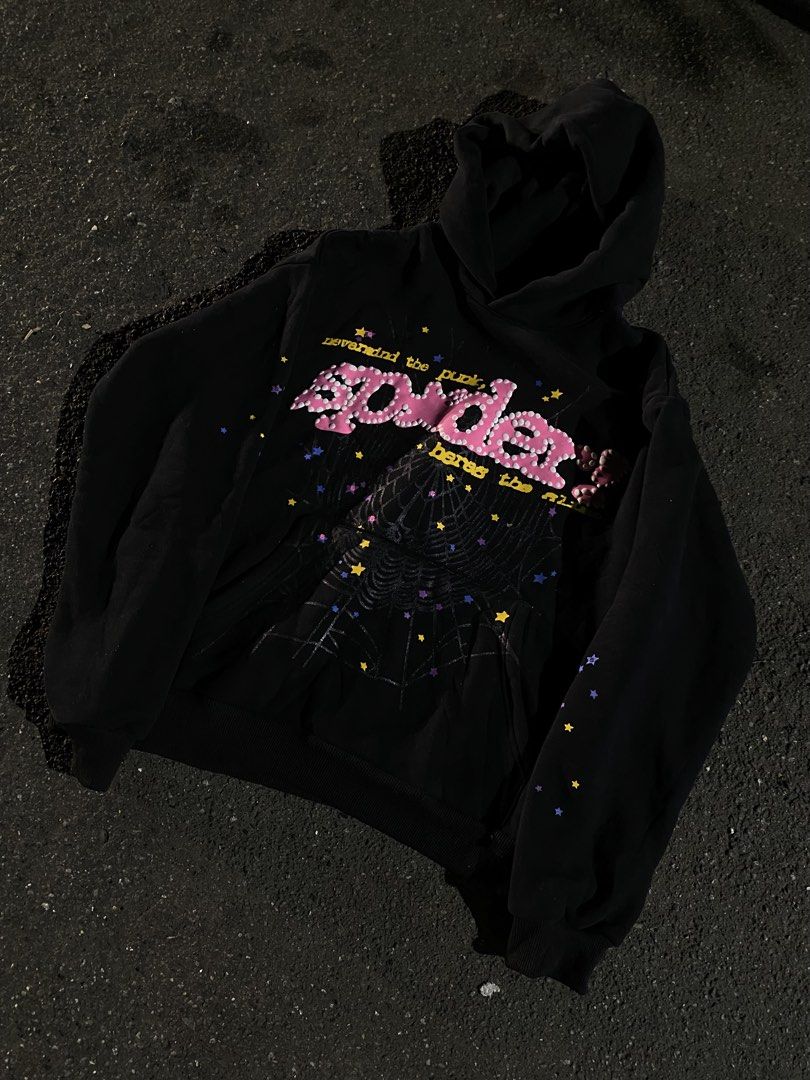 Spider Worldwide Black Hoodie (Authentic ) (Category: Hoodies) located in Quezon City. Submitted by gabdiorr666 (Listing ID 1458711711, Image 2). Description: - Black hoodie with unique spider web graphic. - Features 'nevermind the punk, heres the...' text in pink beads. - Scattered star details on front and sleeves. - Comfortable drawstring hood. - Convenient kangaroo pocket..