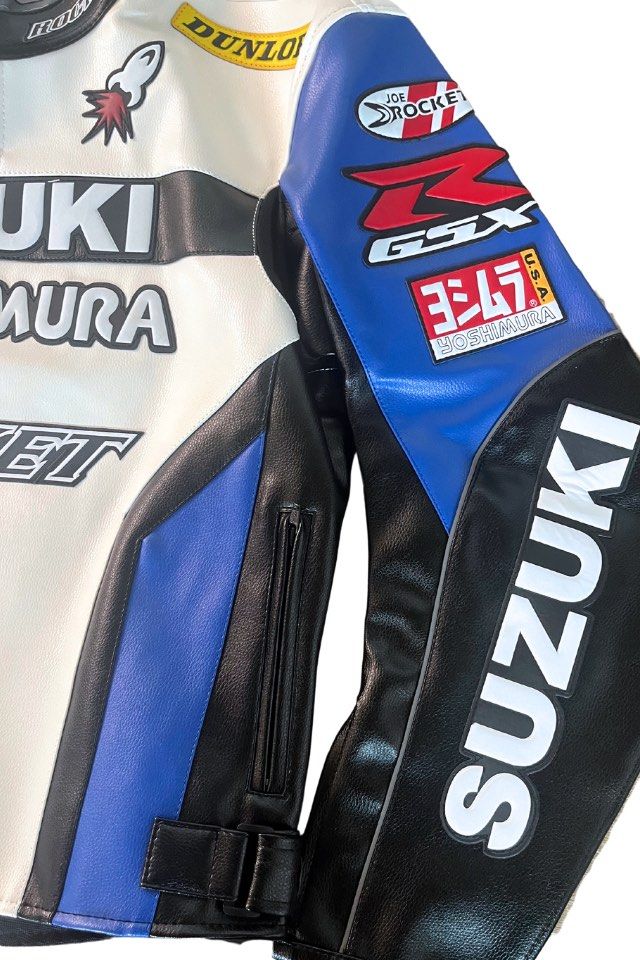 suzuki (Category: Helmets and other Riding Gears) located in Baguio. Submitted by yschoiceph (Listing ID 1458698588, Image 3). Description: This is a white, black, and blue Suzuki Yoshimura Joe Rocket leather racing jacket featuring bold block lettering and sponsor logos across the front and sleeves..