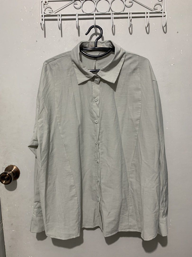 The Ladywore Light Blue Button-Up Shirt (Category: Shirts) located in Mandaluyong City. Submitted by lgariba (Listing ID 1458738854, Image 2). Description: - Light blue button-up shirt by The Ladywork - Textured fabric for a unique feel - Distinctive button detail on the back - Long sleeves with button cuffs - Relaxed fit for comfort - Versatile for casual or semi-formal outfits.