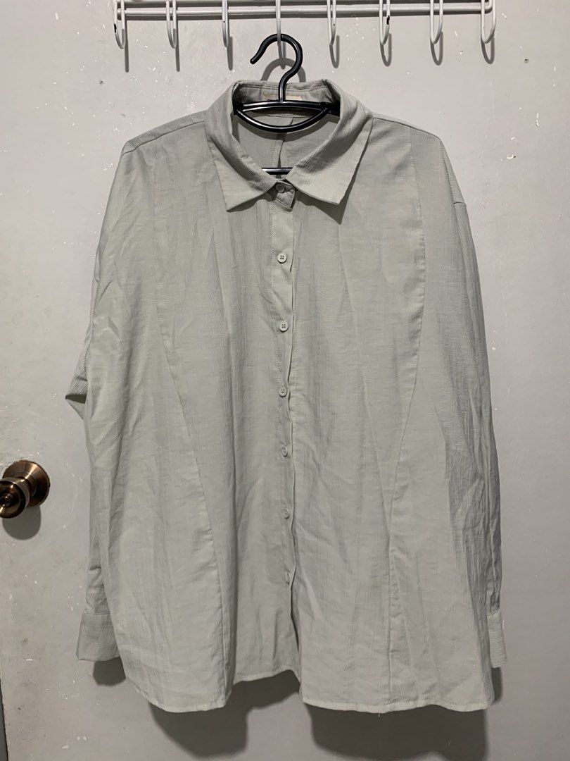 The Ladywore Light Blue Button-Up Shirt (Category: Shirts) located in Mandaluyong City. Submitted by lgariba (Listing ID 1458738854, Image 1). Description: - Light blue button-up shirt by The Ladywork - Textured fabric for a unique feel - Distinctive button detail on the back - Long sleeves with button cuffs - Relaxed fit for comfort - Versatile for casual or semi-formal outfits.