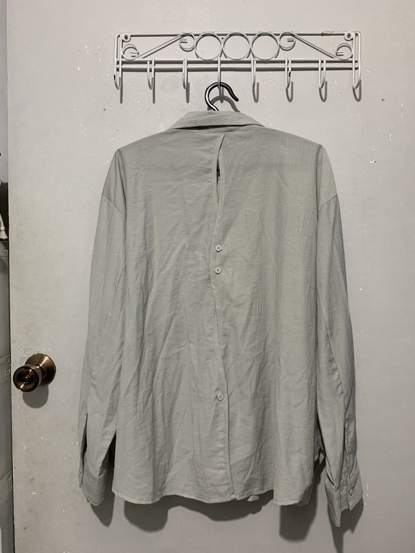 The Ladywore Light Blue Button-Up Shirt (Category: Shirts) located in Mandaluyong City. Submitted by lgariba (Listing ID 1458738854, Image 3). Description: - Light blue button-up shirt by The Ladywork - Textured fabric for a unique feel - Distinctive button detail on the back - Long sleeves with button cuffs - Relaxed fit for comfort - Versatile for casual or semi-formal outfits.